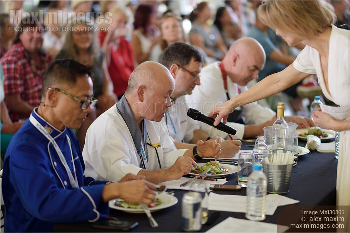 Chefs competition judges commenting on a gourmet meal at BC Seafood Festival Stock photo of Chefs competition judges commenting on a gourmet meal at BC Seafood Festival Buy commercial use license at MaximImages