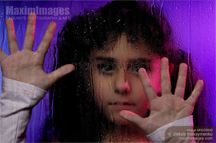 Stock photo of Child Behind Window Pane Buy commercial use license at MaximImages