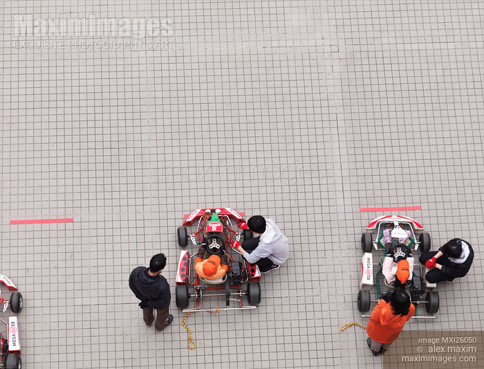 Stock photo of Children riding go-karts Buy commercial use license at MaximImages