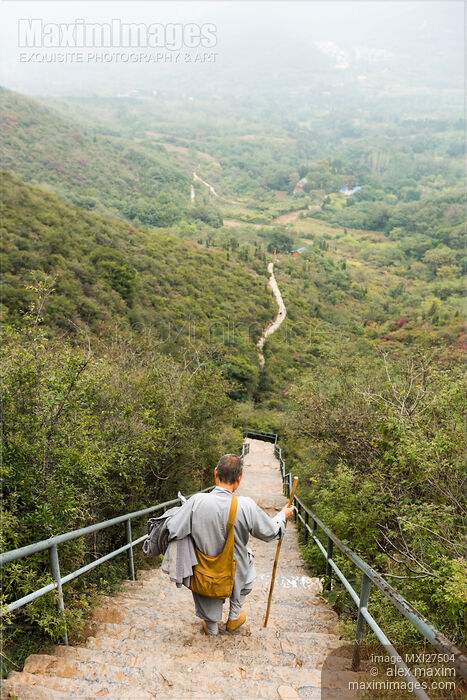 Stock photo of Chinese Buddhist monk walking down the stair at mount Song Buy commercial use license at MaximImages