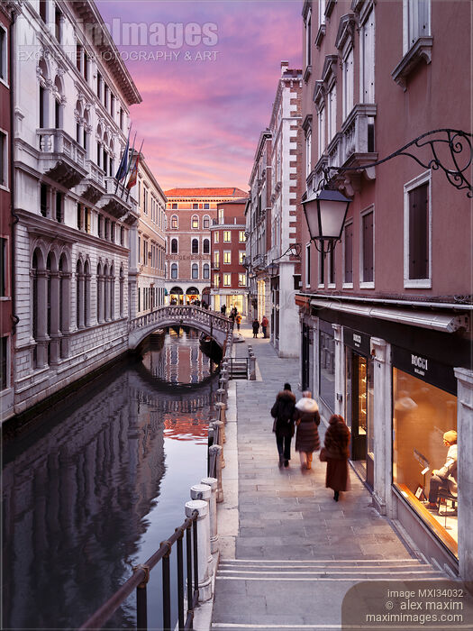 Stock photo of City of Venice sunset street scenery of historic old buildings and a small foot bridge Buy commercial use license at MaximImages