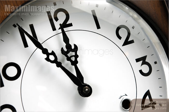 Stock photo of Clock Showing Five Minutes to Twelve Buy commercial use license at MaximImages