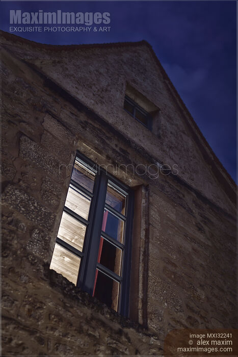 Closed lit from inside window of an old house at night in South of France artistic domestic concept Stock photo of Closed lit from inside window of an old house at night in South of France artistic domestic concept Buy commercial use license at MaximImages