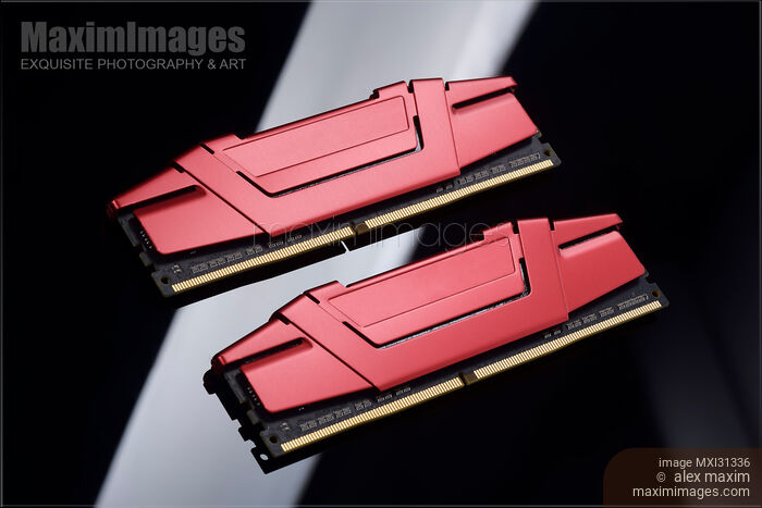 Stock photo of Closeup DDR4 dual-channel computer memory with red heat sinks on black Buy commercial use license at MaximImages