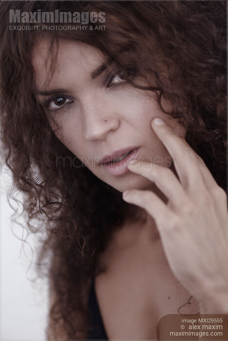 Closeup face portrait of a young brunette woman with a deep expressive look Stock photo of Closeup face portrait of a young brunette woman with a deep expressive look Buy commercial use license at MaximImages