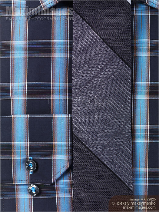 Closeup of a blue tartan shirt with a slim tie Stock photo of Closeup of a blue tartan shirt with a slim tie Buy commercial use license at MaximImages