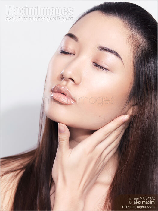 Closeup of a young asian woman face with clean glass skin Stock photo of Closeup of a young asian woman face with clean glass skin Buy commercial use license at MaximImages