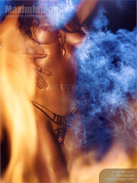 Closeup of beautiful nude body of a native woman dancing naked at night surrounded by fire flames and smoke Stock photo of Closeup of beautiful nude body of a native woman dancing naked at night surrounded by fire flames and smoke Buy commercial use license at MaximImages