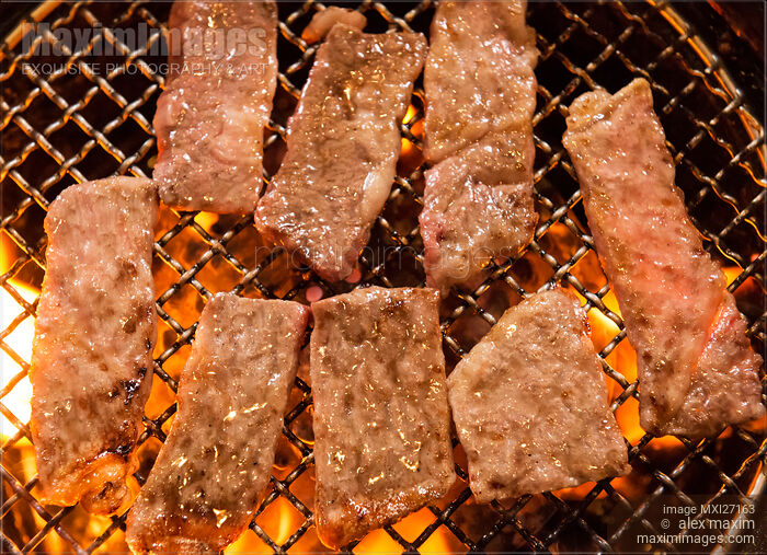 Stock photo of Closeup of beef bbq being grilled on fire Buy commercial use license at MaximImages