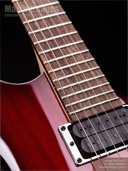 Stock photo of Closeup of electric guitar neck and strings Buy commercial use license at MaximImages