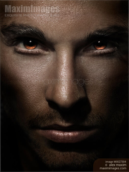 Stock photo of Closeup of man face with shining fierce eyes Buy commercial use license at MaximImages