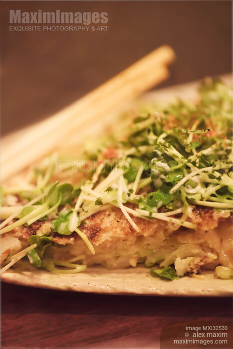 Closeup of Okonomiyaki Japanese dish on a plate cabbage pancake with sprouts topping in Japan Stock photo of Closeup of Okonomiyaki Japanese dish on a plate cabbage pancake with sprouts topping in Japan Buy commercial use license at MaximImages