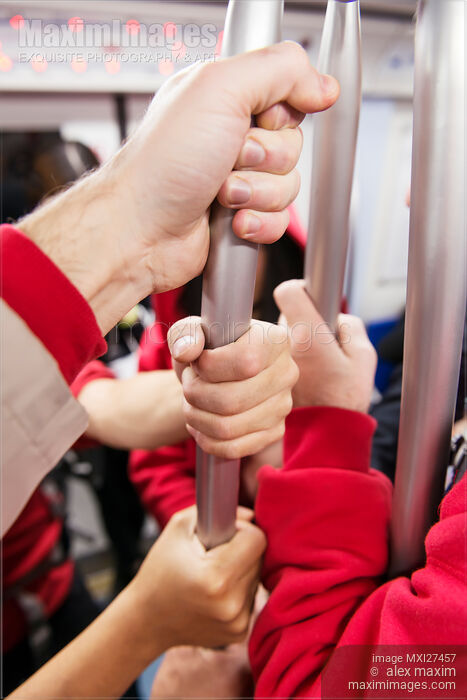 Stock photo of Closeup of people hands in subway Buy commercial use license at MaximImages