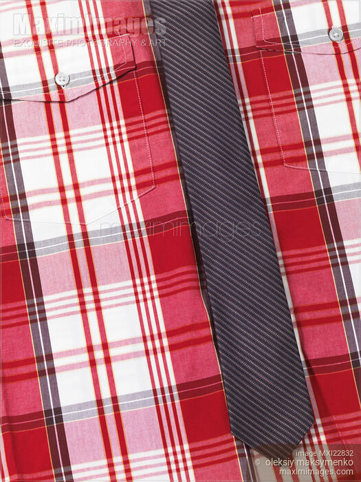 Closeup of red tartan shirt with a slim necktie Stock photo of Closeup of red tartan shirt with a slim necktie Buy commercial use license at MaximImages