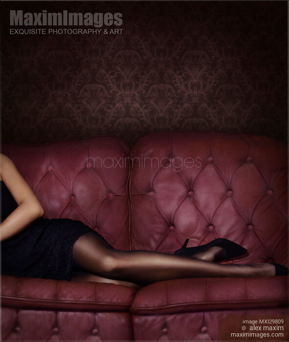 Closeup of sexy legs in black stocking of woman lying on luxurious dark pink tufted couch Stock photo of Closeup of sexy legs in black stocking of woman lying on luxurious dark pink tufted couch Buy commercial use license at MaximImages
