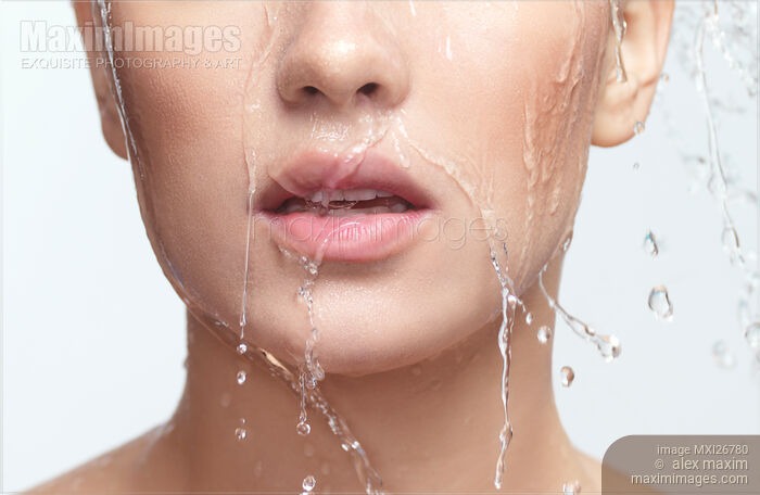 Stock photo of Closeup of woman face with healthy skin, mouth and lips, with water running over it Buy commercial use license at MaximImages