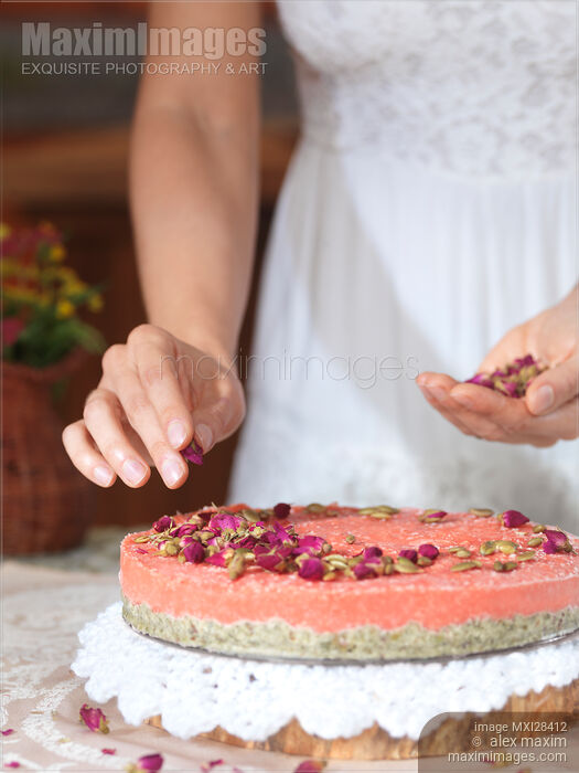 Stock photo of Closeup of woman hands making cake Buy commercial use license at MaximImages