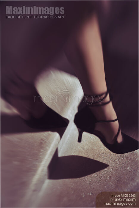 Stock photo of Closeup of woman legs in black high heel shoes walking down the stairs Buy commercial use license at MaximImages