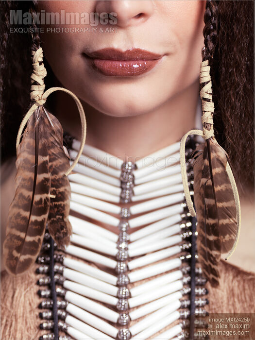 Closeup of woman wearing aboriginal necklace and feathers Stock photo of Closeup of woman wearing aboriginal necklace and feathers Buy commercial use license at MaximImages