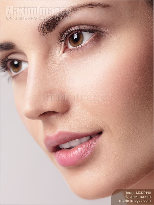 Closeup of young beautiful woman face with clean glowing skin Stock photo of Closeup of young beautiful woman face with clean glowing skin Buy commercial use license at MaximImages
