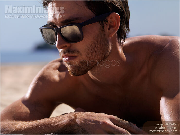Closeup portrait of a man in sunglasses at the beach Stock photo of Closeup portrait of a man in sunglasses at the beach Buy commercial use license at MaximImages