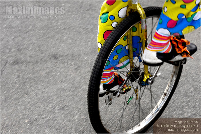 Stock photo of Clown on Unicycle Buy commercial use license at MaximImages