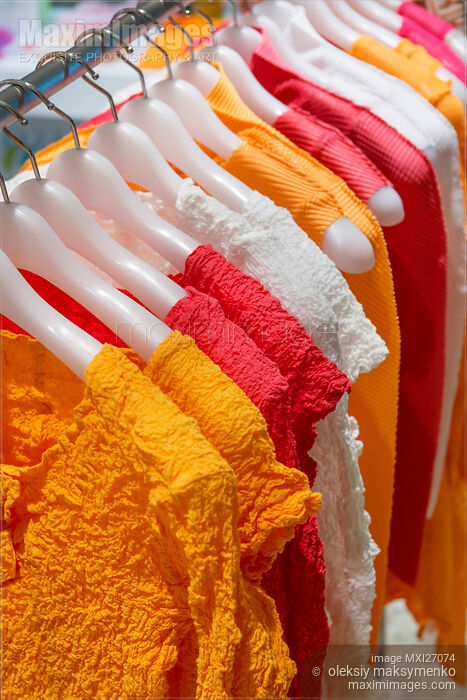 Stock photo of Colorful clothes on hangers Buy commercial use license at MaximImages