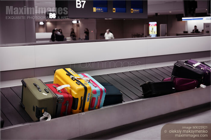 Colorful suitcases on airport baggage conveyor carousel Stock photo of Colorful suitcases on airport baggage conveyor carousel Buy commercial use license at MaximImages