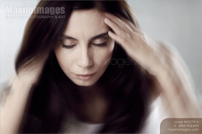 Stock photo of Conceptual photo of woman with her head spinning Buy commercial use license at MaximImages