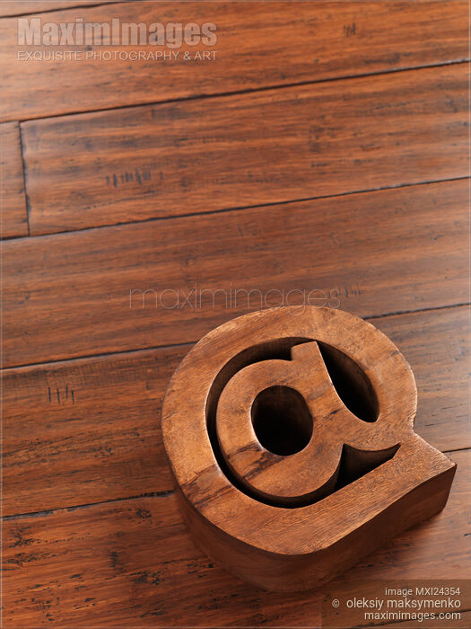 Stock photo of Contact and email symbol AT made of wood Buy commercial use license at MaximImages