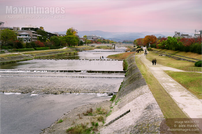 Couple crossing Kamo River by walking on stepping stones Kyoto city scenery Stock photo of Couple crossing Kamo River by walking on stepping stones Kyoto city scenery Buy commercial use license at MaximImages
