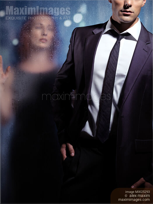 Couple dramatic portrait man leaving woman behind glass Stock photo of Couple dramatic portrait man leaving woman behind glass Buy commercial use license at MaximImages