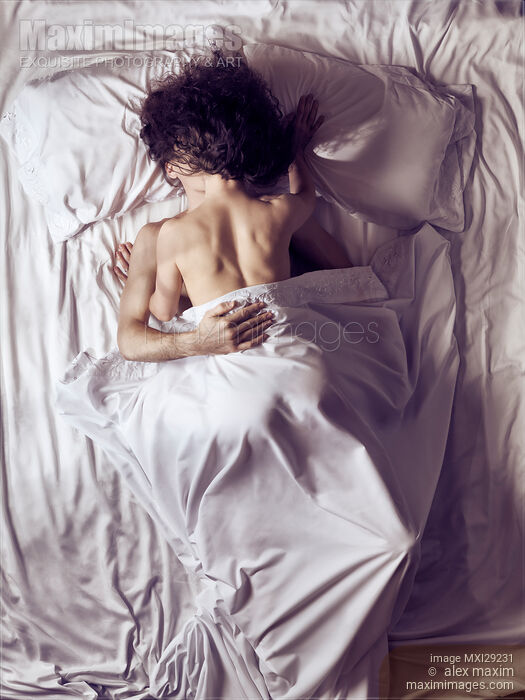 Couple kissing in bed in the morning Stock photo of Couple kissing in bed in the morning Buy commercial use license at MaximImages