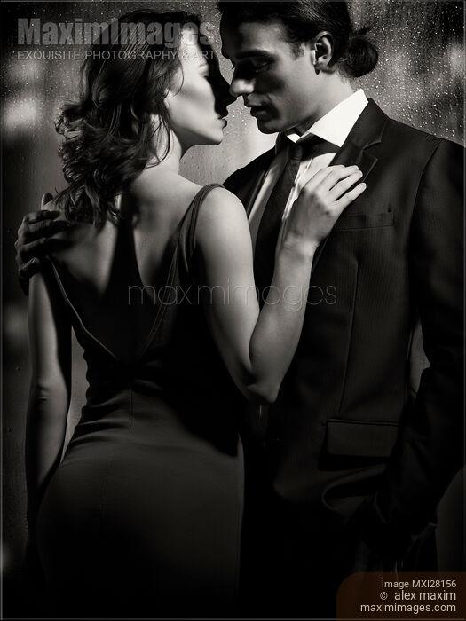 Stock photo of Couple kissing in front of window Black and white Buy commercial use license at MaximImages
