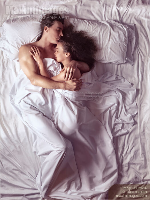 Couple sleeping together in bed in morning sunlight Stock photo of Couple sleeping together in bed in morning sunlight Buy commercial use license at MaximImages