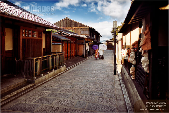 Couple with Japanese parasols in traditional kimono walking on street in Kyoto Japan Stock photo of Couple with Japanese parasols in traditional kimono walking on street in Kyoto Japan Buy commercial use license at MaximImages