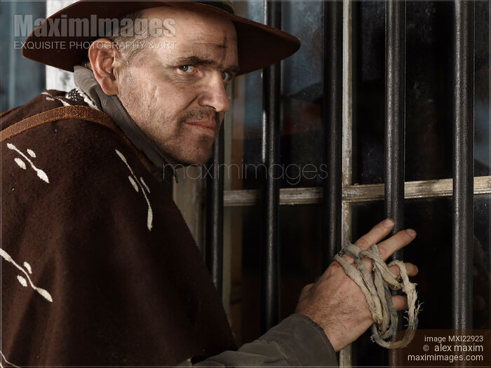 Stock photo of Cowboy Attempting to Rob a Bank Buy commercial use license at MaximImages