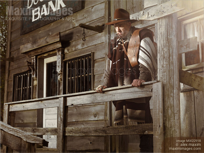 Stock photo of Cowboy Waiting Outside of a Bank Building Buy commercial use license at MaximImages