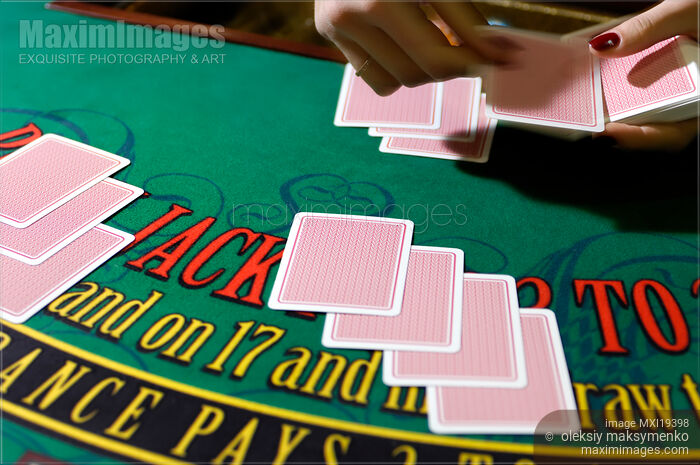 Stock photo of Croupier Dealing Out the Cards at a Blackjack Table Buy commercial use license at MaximImages