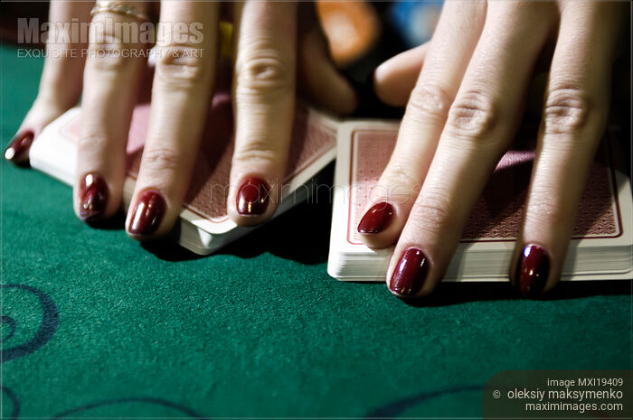 Stock photo of Croupier Shuffling the Cards at a Blackjack Table Buy commercial use license at MaximImages