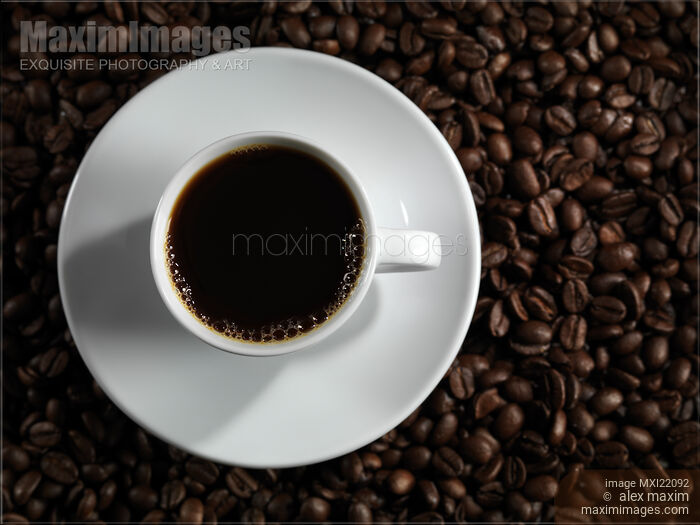 Cup of Coffe on Coffee Beans Stock photo of Cup of Coffe on Coffee Beans Buy commercial use license at MaximImages