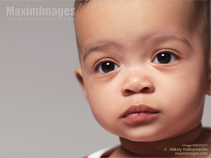 Stock photo of Cute black baby girl closeup portrait Buy commercial use license at MaximImages