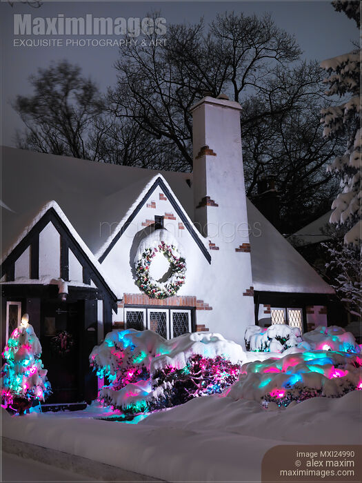 Stock photo of Cute family house decorated with Christmas lights Buy commercial use license at MaximImages