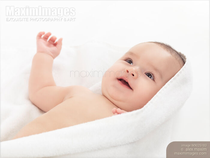 Cute smiling baby boy cuddling in towel Stock photo of Cute smiling baby boy cuddling in towel Buy commercial use license at MaximImages