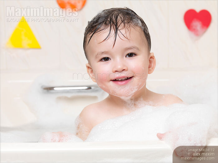 Cute smiling baby boy enjoying a foam bath Stock photo of Cute smiling baby boy enjoying a foam bath Buy commercial use license at MaximImages