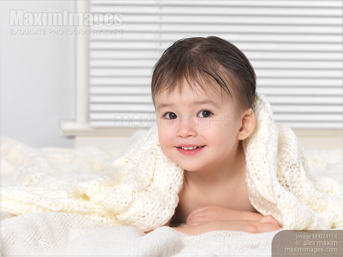 Cute smiling baby boy under a blanket Stock photo of Cute smiling baby boy under a blanket Buy commercial use license at MaximImages