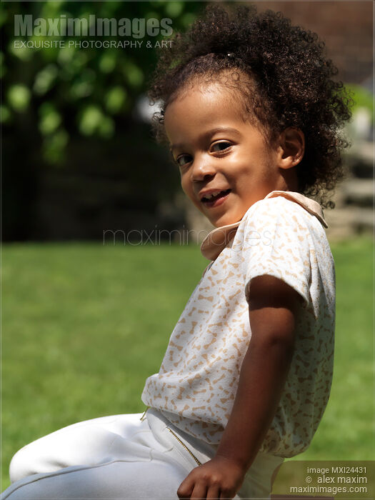 Stock photo of Cute smiling black girl Buy commercial use license at MaximImages