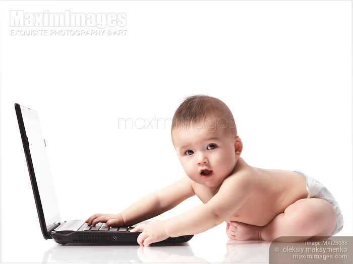 Stock photo of Cute surprized baby in diaper playing with computer Buy commercial use license at MaximImages