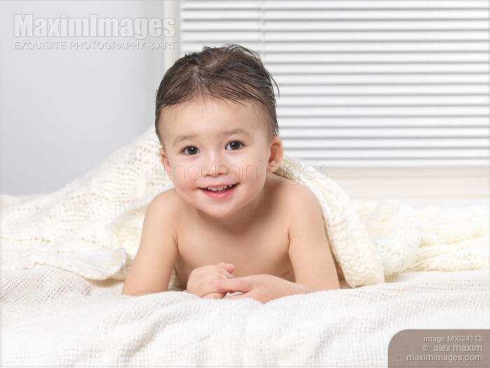 Cute two year old baby boy under a blanket Stock photo of Cute two year old baby boy under a blanket Buy commercial use license at MaximImages
