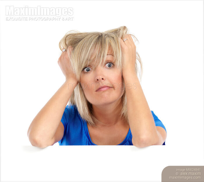 Stock photo of Desperate woman pulling her hair Buy commercial use license at MaximImages